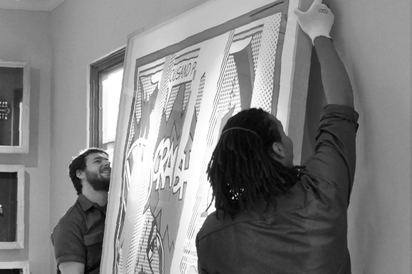 Displays FAS Team Members installing art piece
